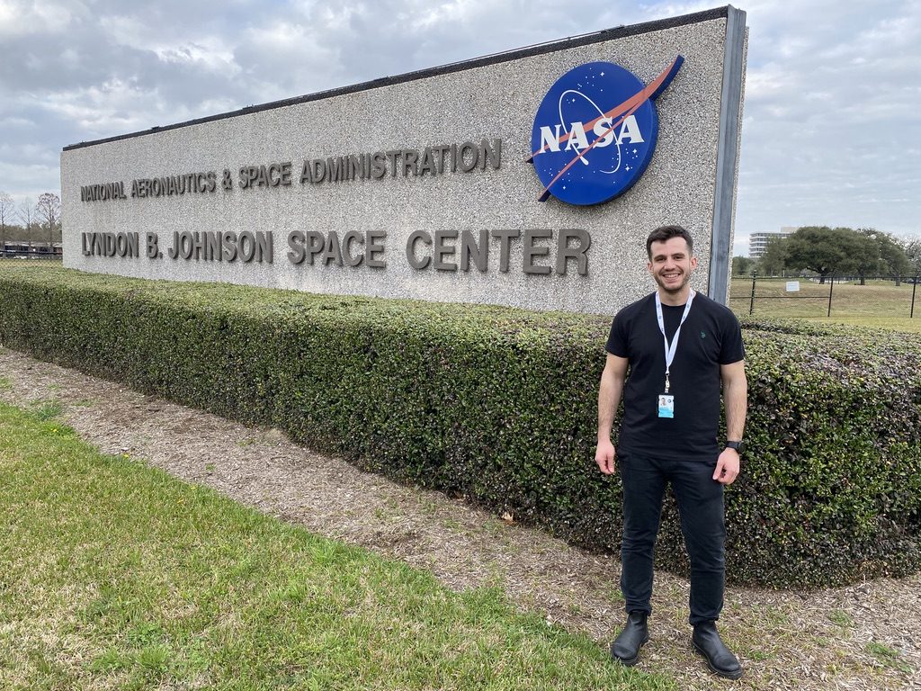 Michail Arvanitidis outside the NASA Lyndon B. Johnson Space Center sign, Houston