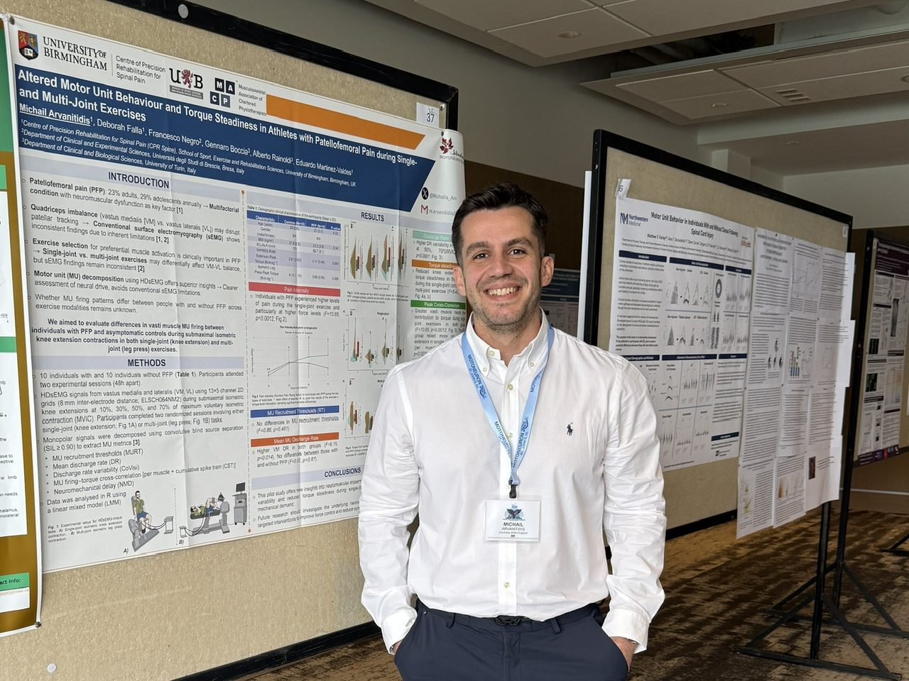 Michail Arvanitidis beside his poster on motor unit behaviour in patellofemoral pain