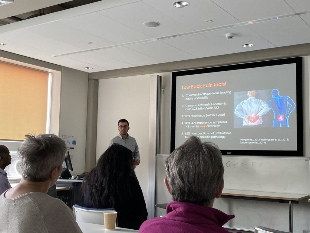 Michail Arvanitidis presenting low back pain research to a Patient and Public Involvement audience